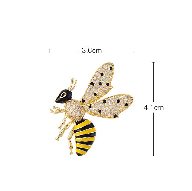 Gold-tone bumblebee brooch with black and yellow striped body and rhinestone-embellished wings, shown with dimension lines indicating 3.6cm width and 4.